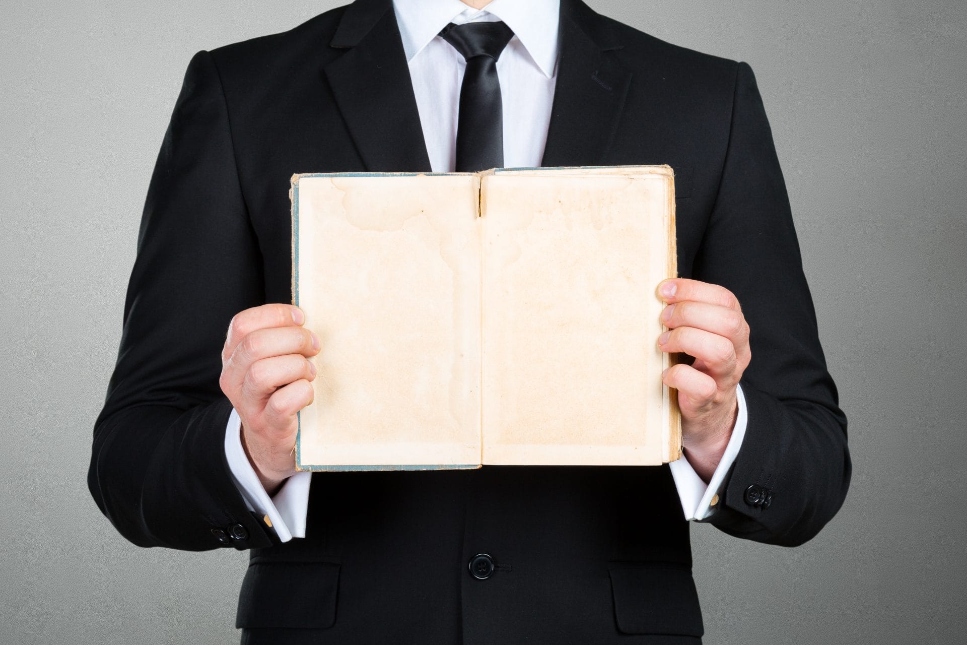 Unrecognizable businessman holding a book closeup