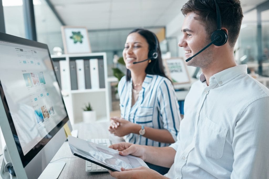 Call center, computer and team with document for customer service, crm and telemarketing in office.