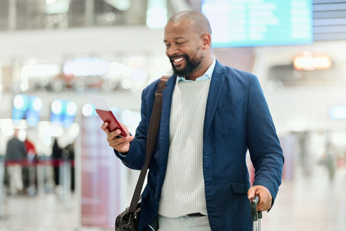 Businessman, phone and smile with luggage for travel, journey or texting in communication at the ai