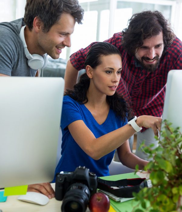 Team of graphic designers working at desk in office